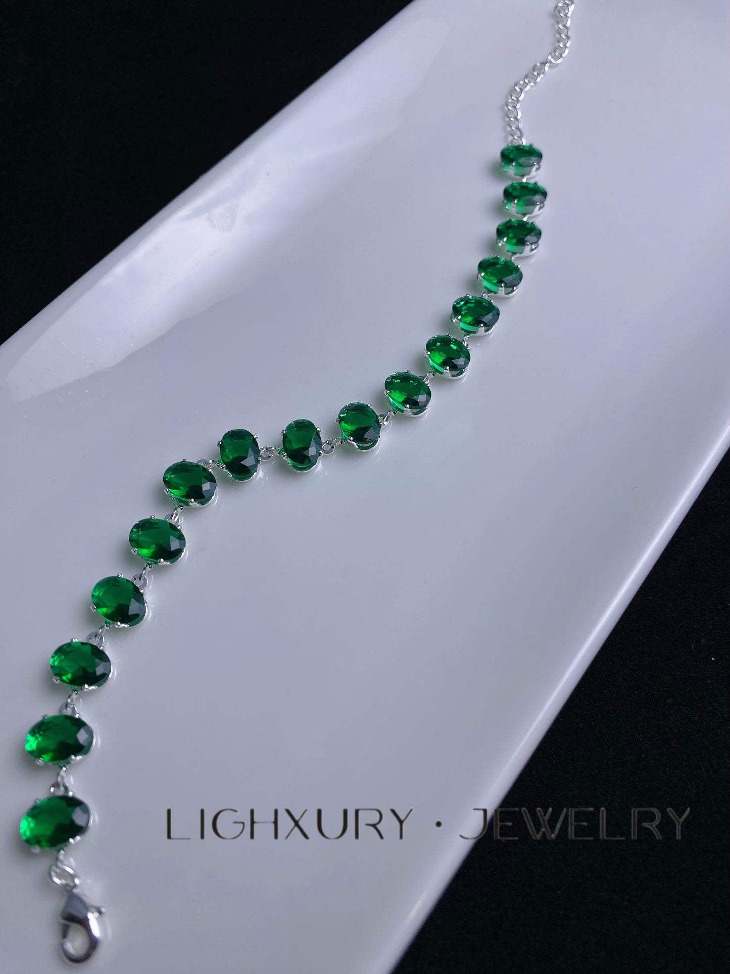 Platinum-Plated Oval Emerald Bracelet: A Captivating Symphony of Green Elegance